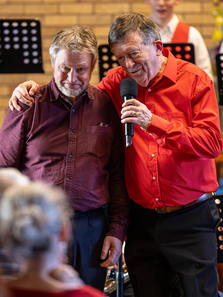 Founder Richard Michael singing with a guest performer at a FYJO concert