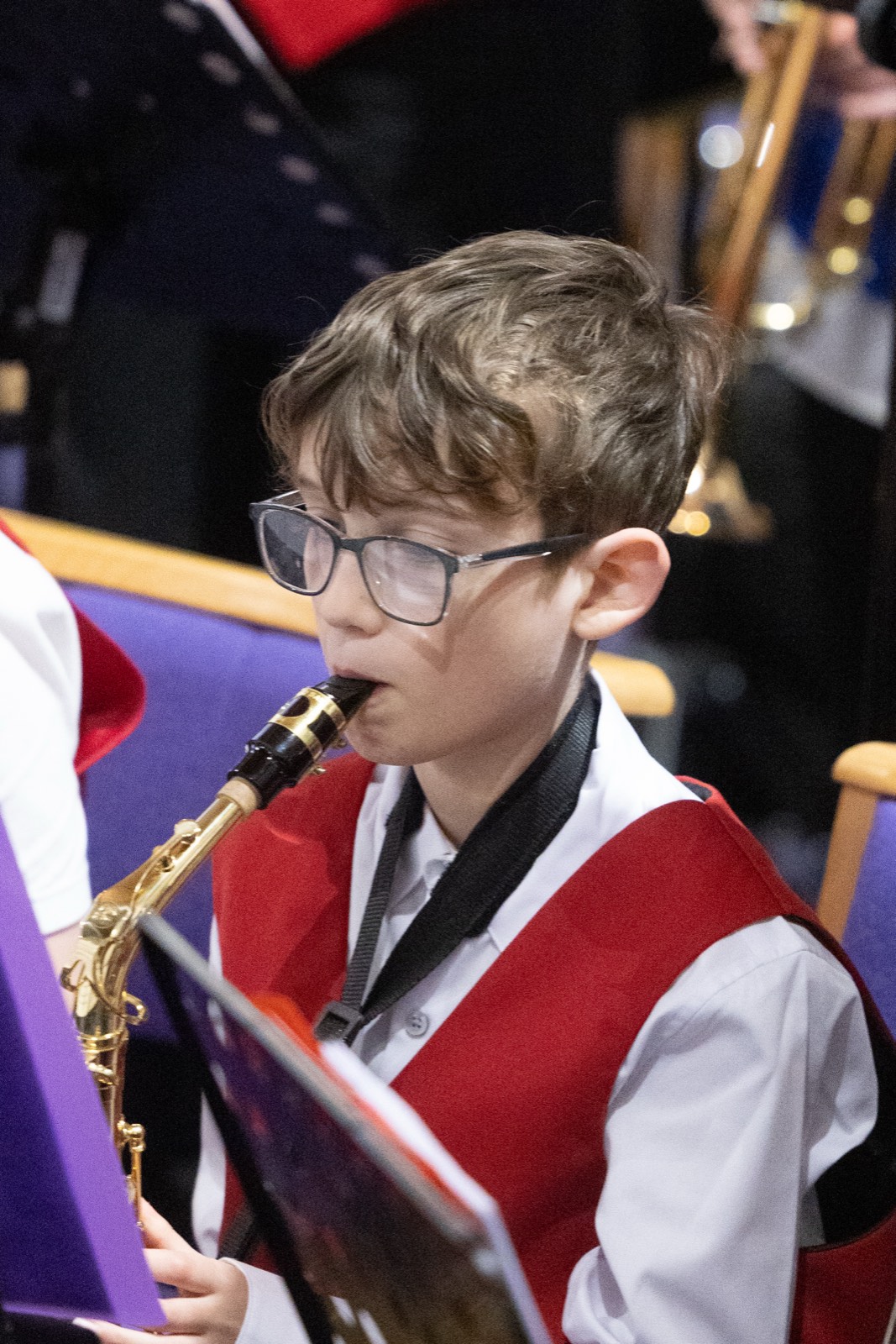 Young saxophonist playing in concert